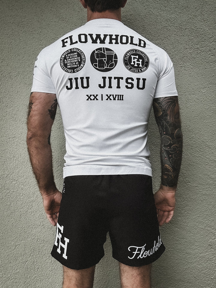 Model wearing Flowhold’s Defeater Fight Shorts and rashguard set– back view
