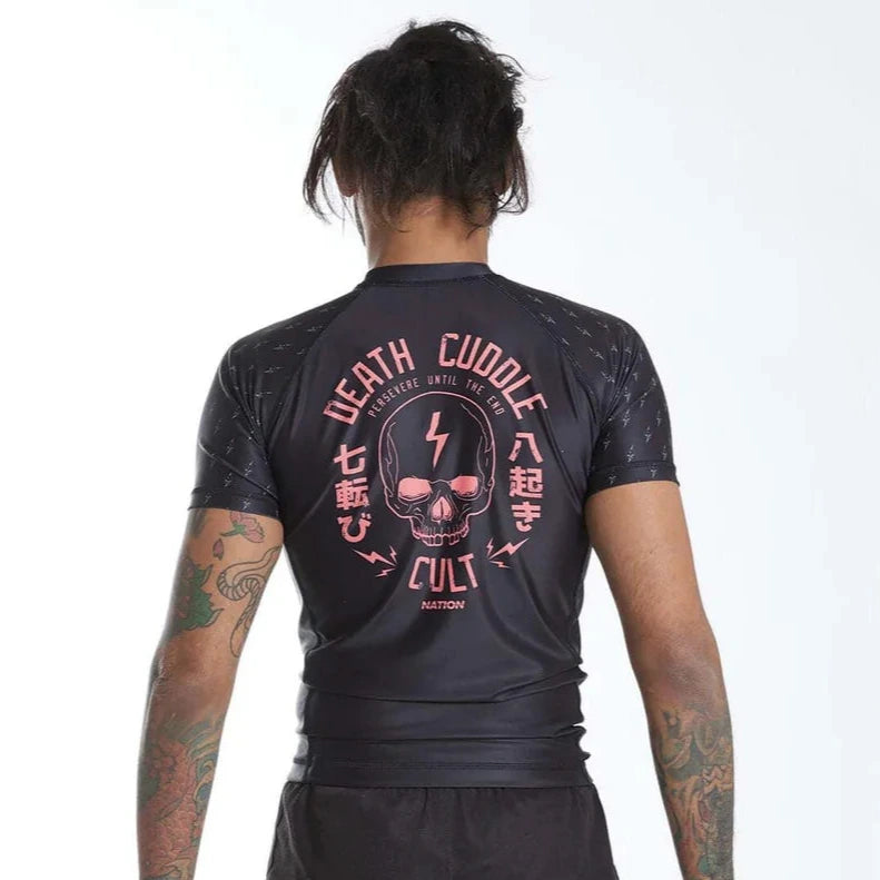 Back view of male model wearing Nation Athletic Death Cuddle Cult Rash guard and Shorts – lightweight black BJJ and MMA training set