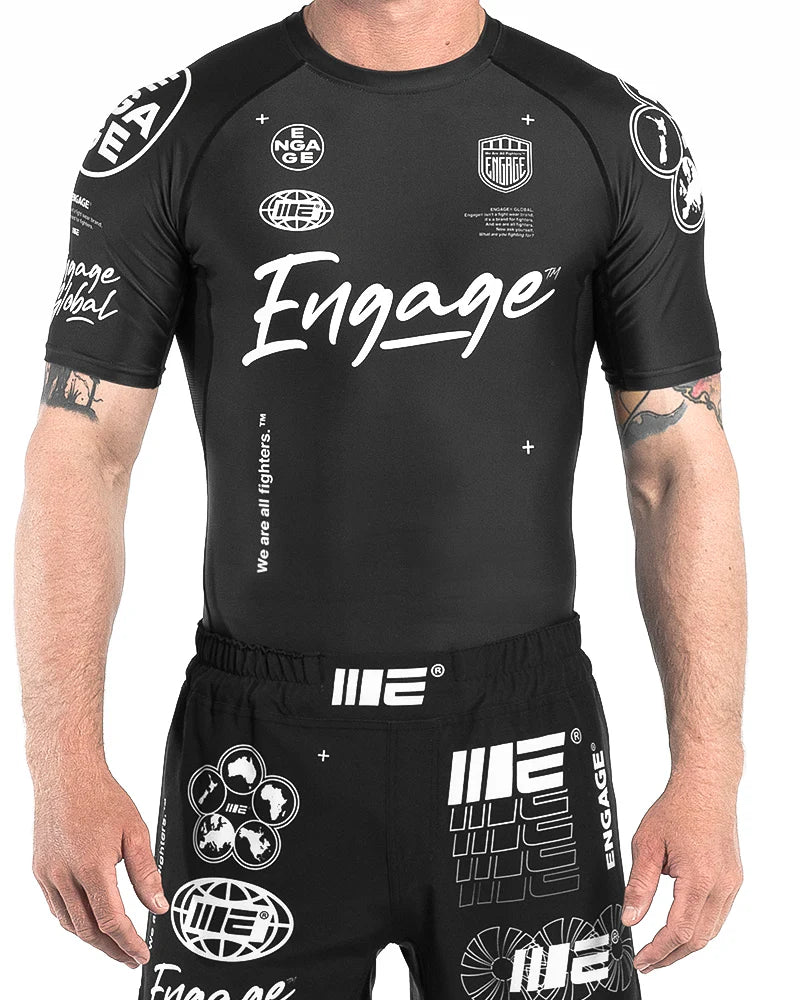 Front view of Engage Billboard Short Sleeve Rash Guard Black worn by model